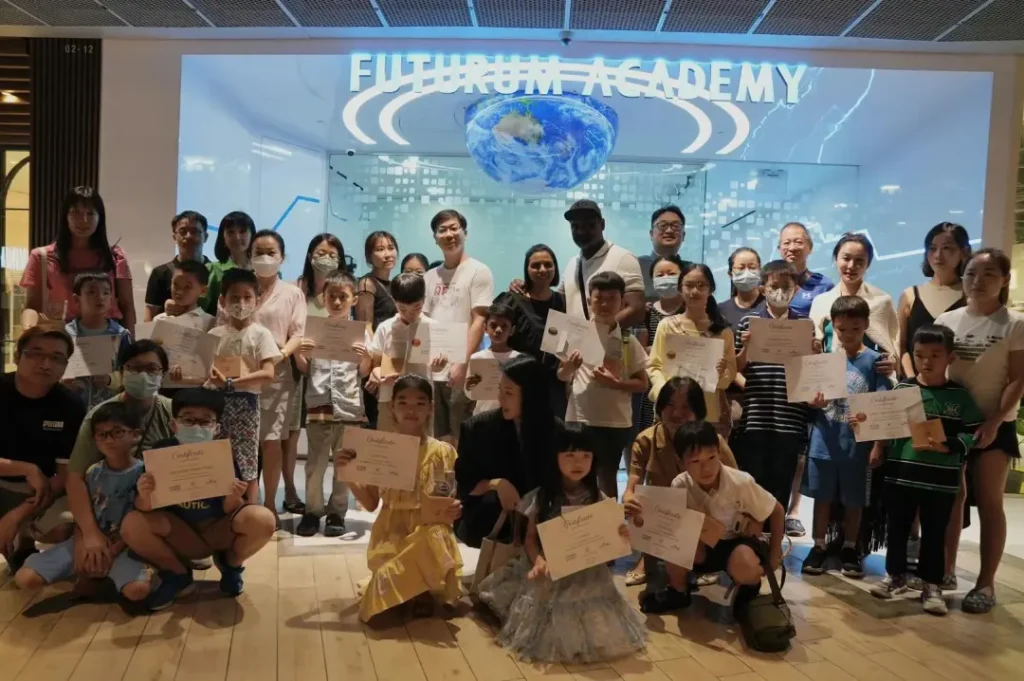 Families holding certificates at a ceremony outside a Futurum Academy campus